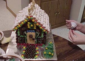 Sticking on lots of m&ms on the Lim house.