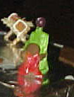 See the green and purple shepherd behind? Not quite proportional for the manger, and a wee bit tacky, we thought. So we scrapped the idea for gingerbread people .