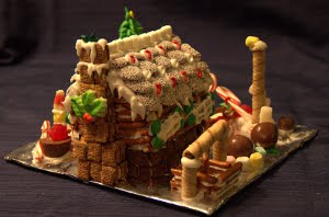 Kaitlyn's house from the back. Check out the realistic chimney complete with layered stones. The wreath at the back is from the cake decorating store also.